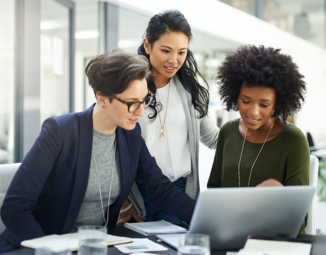 business women collaborating on laptop