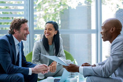 woman and two men sitting together while prepping for an executive interview