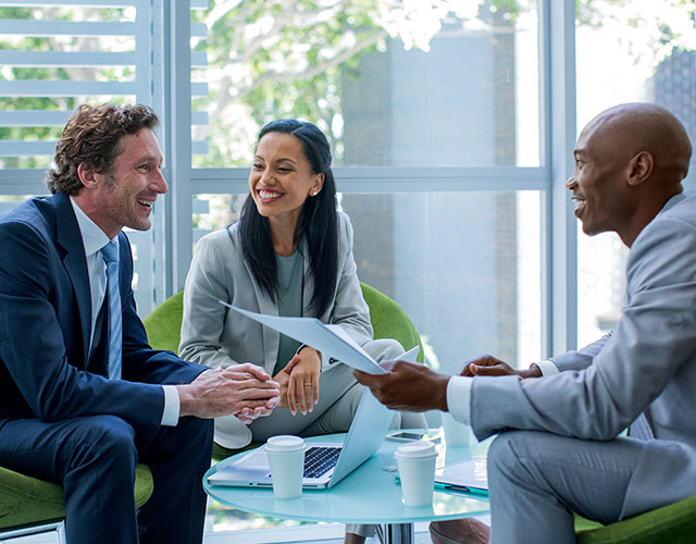 woman and two men sitting together while prepping for an executive interview